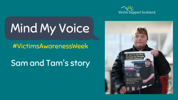 Person holding a poster for Victim Support Scotland's awareness campaign.