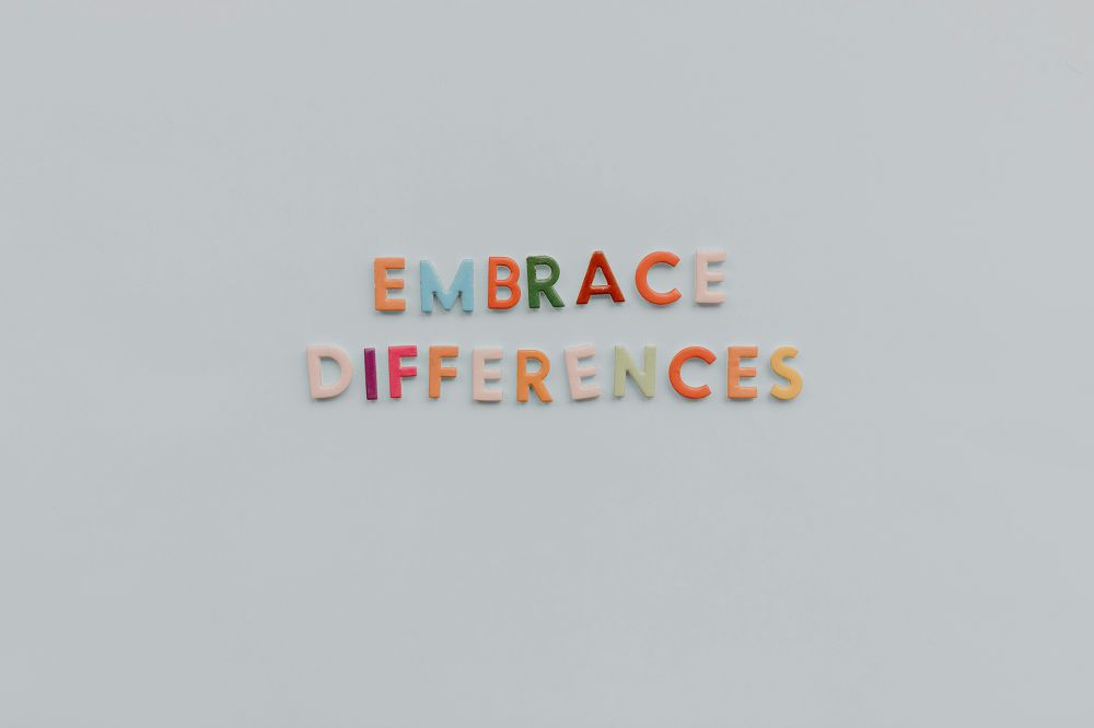 A white background featuring color-coded letters, symbolizing the importance of embracing and celebrating differences.