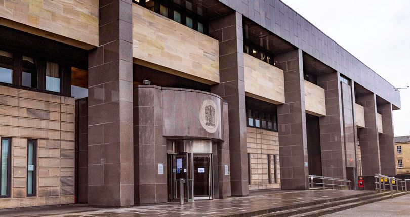Facade of the sheriff court with a large emblem above the entrance.