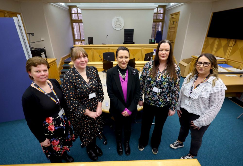 Group of five individuals from Victim Support Scotland standing in a courtroom.